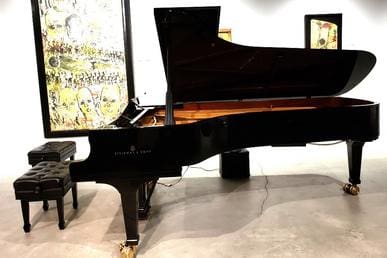 A black piano sitting in the middle of a room.